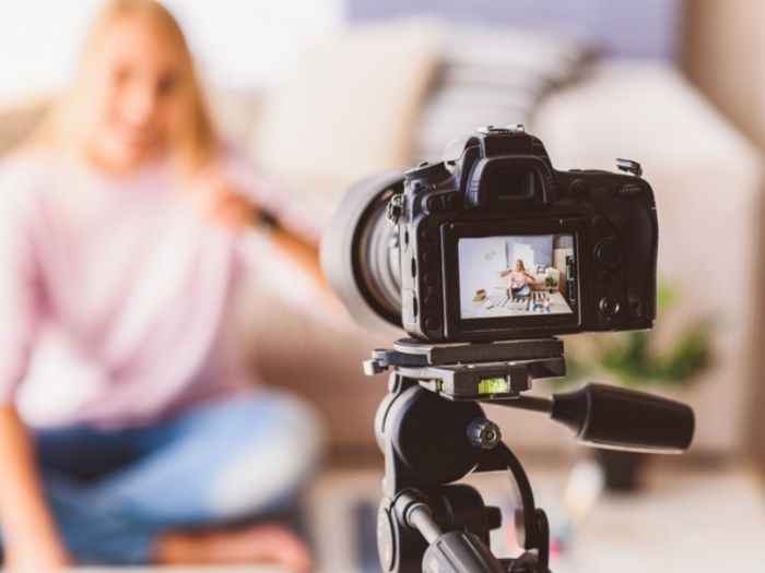 Camera on tripod looking at blurred out woman