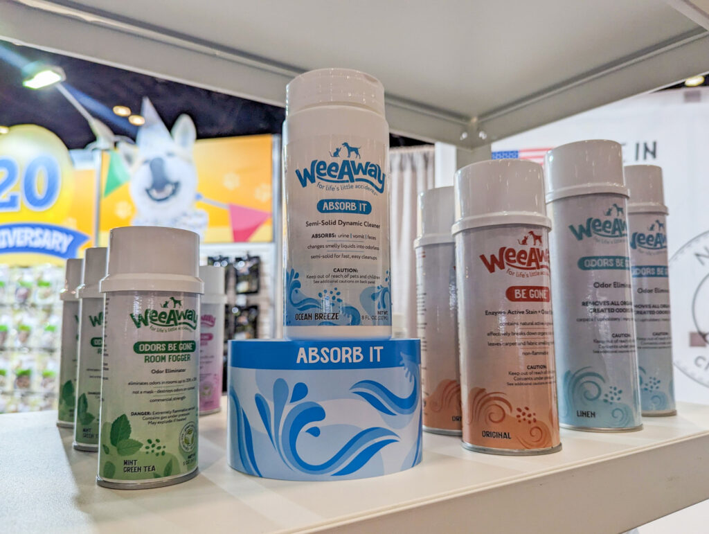 A canister of Absorb It on shelf with other Wee Away cleaning products