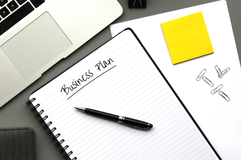 note book with pen that says business plan | 3 Things Every Small Pet Business Plan Needs