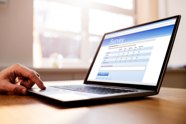 person answering survey on laptop | Highlights from the BlogPaws Community Survey