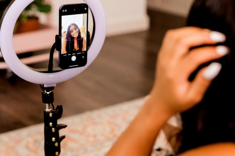 woman recording video on phone | How to Repurpose Video Content for Instagram and TikTok