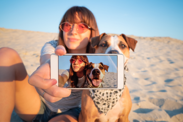 woman taking selfie with dog at the beach | 11 Ways To Grow an Instagram Account